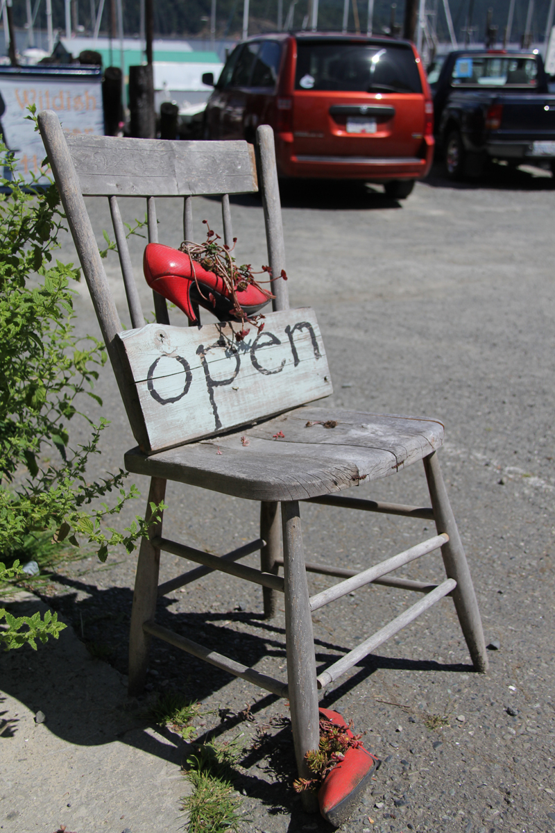 Open chair with red shoes outside the shop